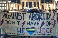 Pro choice protest, bloody week, in front of Brandenburg Gate, protesters holding a poster which says "against abortion? Don't habe one, We heart choice (heart with rainbowflag)
