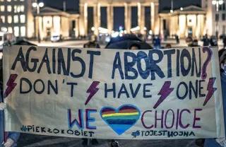 Pro choice protest, bloody week, in front of Brandenburg Gate, protesters holding a poster which says "against abortion? Don't habe one, We heart choice (heart with rainbowflag)