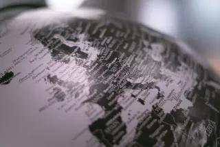 Grayscale photo of desk globe