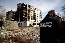 A war crimes prosecutor team inspects buildings that were destroyed by Russian shelling in Borodyanka, Ukraine, on Thursday. | REUTERS